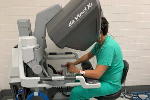 Person on a robotic-assisted surgery system console.